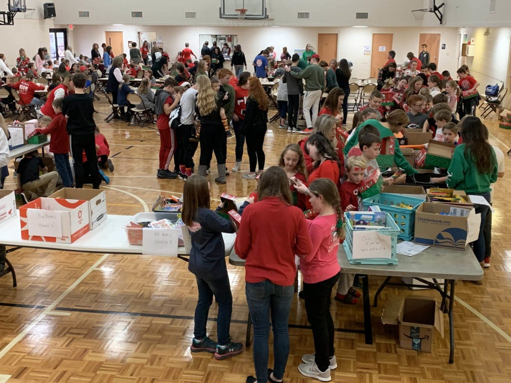 Students from Cornerstone Christian Academy (CCA) participate in the school’s packing party by assembling shoeboxes for Operation Christmas Child.